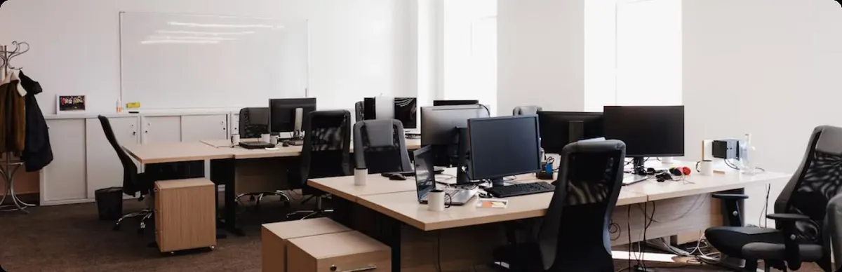 Open-plan office with desks and monitors